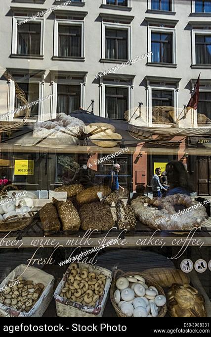 Riga, Latvia, Reflections of buildings and people in a bakery window