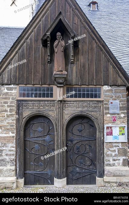 Wooden figure of John the Baptist above the portal of the Protestant St. John's Church in Wernigerode, Saxony-Anhalt, Germany, Europe