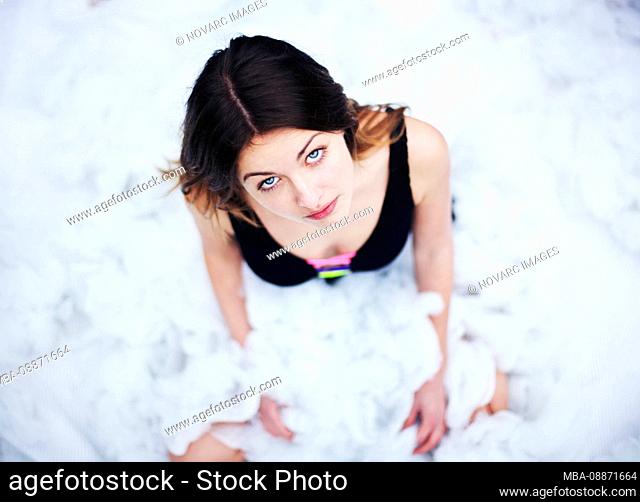 Young woman sitting on cotton balls