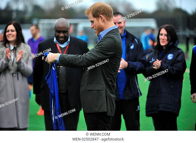 Prince Harry is seen receiving a football shirt from refugees at the UCLAN sports arena, Preston. The Prince also watched people with disabilities and young...