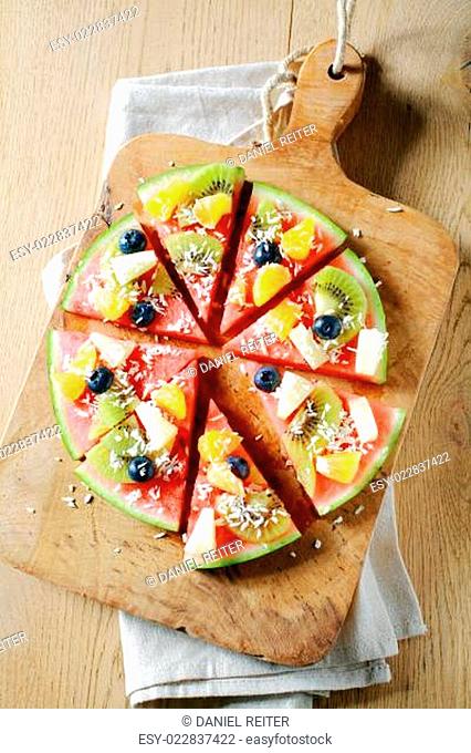 Tropical fruit watermelon pizza on a board