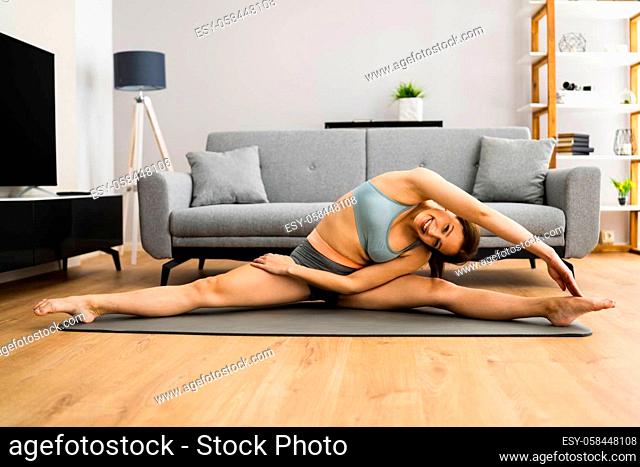 Woman Doing Fitness Stretching Exercise Workout At Home
