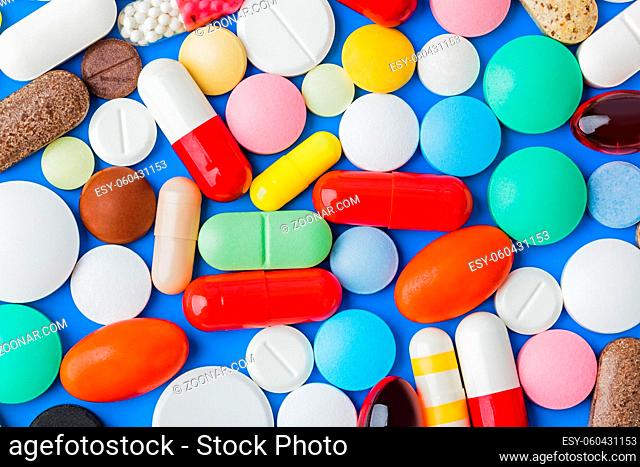 Heap of pills - blue medical background