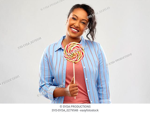 happy african american woman with big lollipop