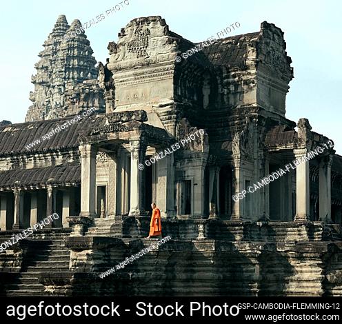 Siem Reap, Cambodia - January 19, 2011: A monk in his orange robe walking on the platform of the Angkor Wat complex