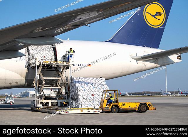 07 April 2020, Bavaria, Munich: A Lufthansa Cargo freighter is unloaded on the apron from the airport. The aircraft with 8 million protective masks had taken...