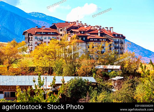 Bansko, Bulgaria town view with houses and colorful yellow autumn trees