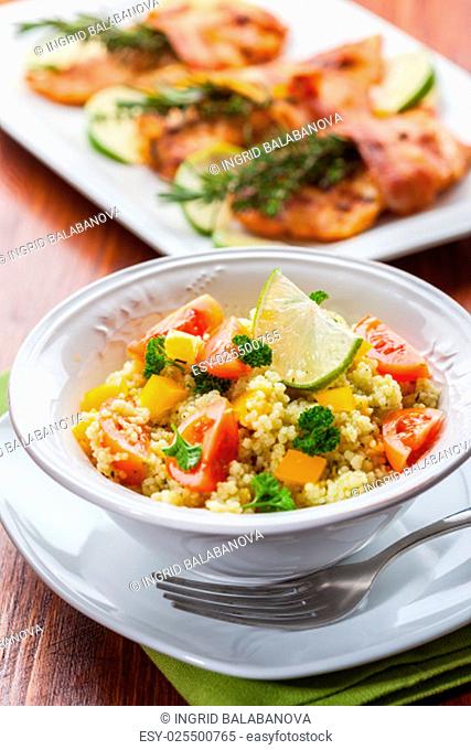 Fresh couscous salad for summer with tomato, pepper with olives