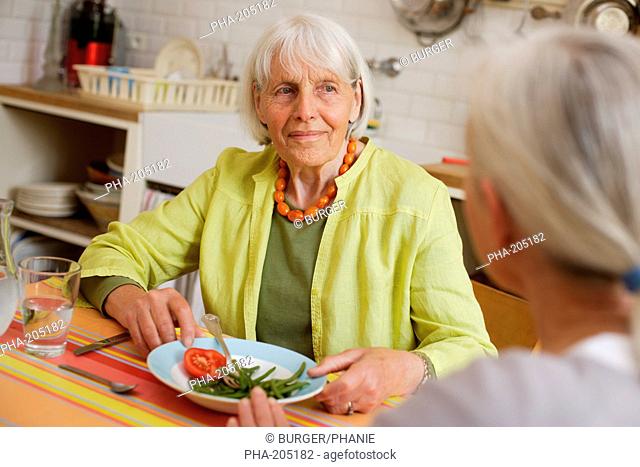 80 years old woman having lunch at home