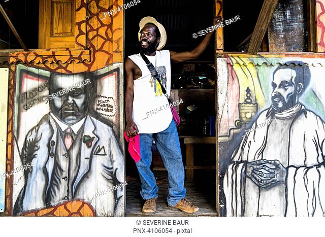 Rastaman in front of a painted hut figuring the king Selassie, Hillsborough, Carriacou, Grenada, West Indies, Caribbean islands