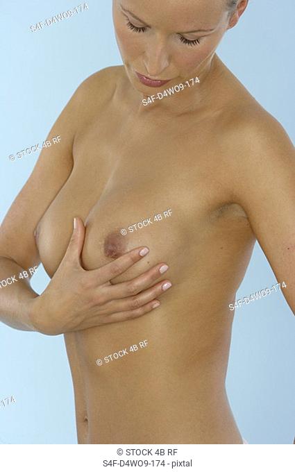Young naked woman Touching, Cancer, Breast Cancer, Prevention, Surgery her chest part of, close-up