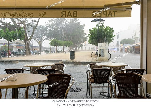 Heavy rainfall viewed through the open front of a bar on the Costa Brava, Spain