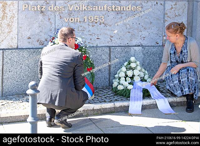 16 June 2021, Berlin: Alexandra Hildebrandt (r), head of the Wall Museum, and an envoy from the Slovak Embassy lay wreaths at the People's Uprising Square next...