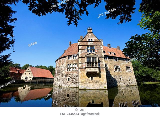 Reflection of moated castle in water, Vischering Castle, Ludinghausen, North Rhine-Westphalia, Germany