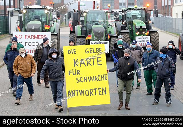 03 December 2020, Mecklenburg-Western Pomerania, Waren: Dairy farmers block the access road to Molkerei Müritz Milch GmbH with their tractors