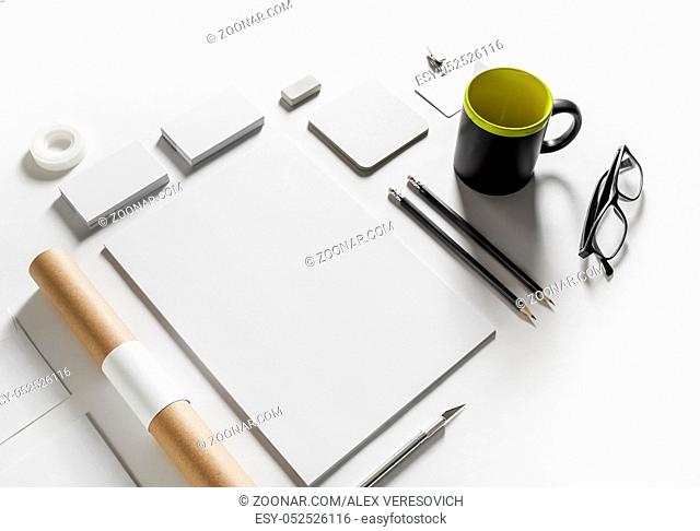 Photo of blank stationery set on white paper background. Corporate identity template. Responsive design mockup. Top view