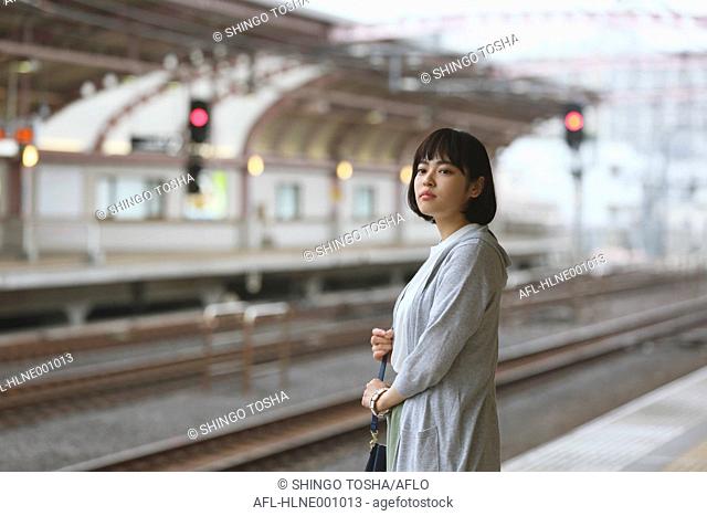 Young Japanese woman at a train station