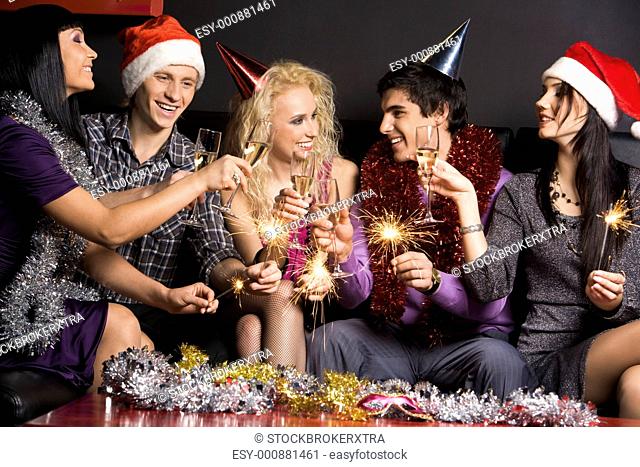 Company of attractive people having fun on Christmas night