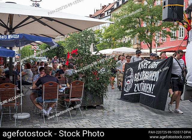 25 July 2022, Bavaria, Bayreuth: Participants take part in an anti-Wagner demonstration in downtown Bayreuth on Maximilianstraße street in front of the tax...