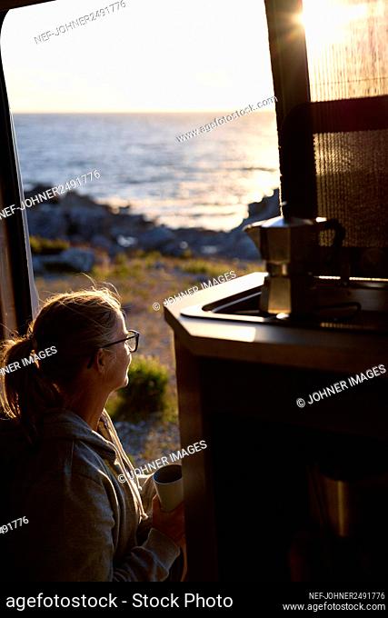 Woman at sunset looking at view