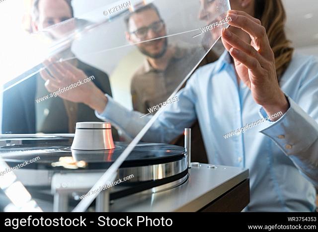 Couple choosing turntable record player in a Hi-Fi or music store