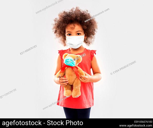 little african american girl in mask with teddy