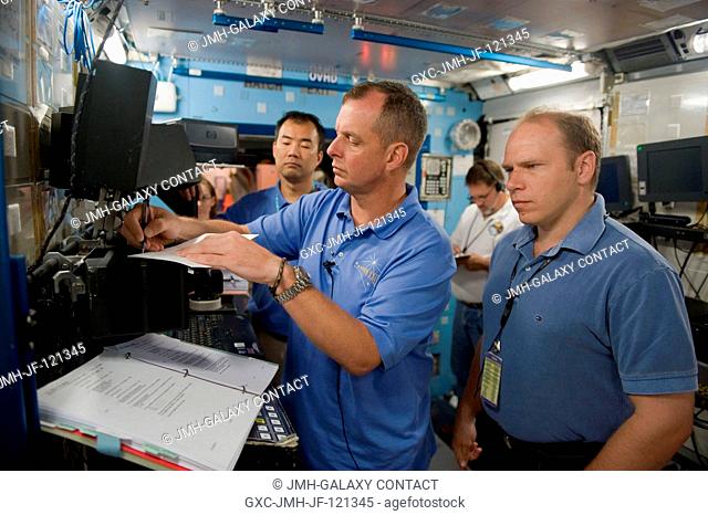 Cosmonaut Oleg Kotov (right), Expedition 22 flight engineer and Expedition 23 commander; NASA astronaut T.J. Creamer and Japan Aerospace Exploration Agency...