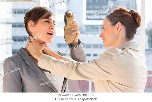 Businesswoman defending herself from her colleague strangling her