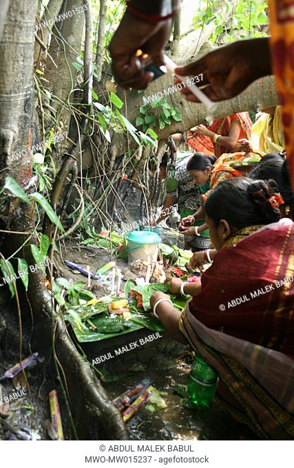 Women from Hindu community offering puja at the root of a Banyan tree, on ‘Pahela Baishakh’, the Bangla New Year 1415 Chittagong, Bangladesh April 14, 2008