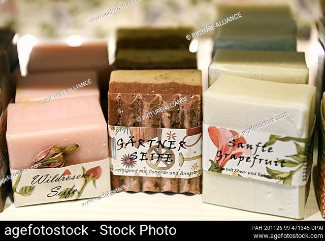 24 November 2020, Berlin: Garden soap with clay and pumice stone, wild rose soap and ""gentle grapefruit"" with shea and cocoa butter are offered in the shop...