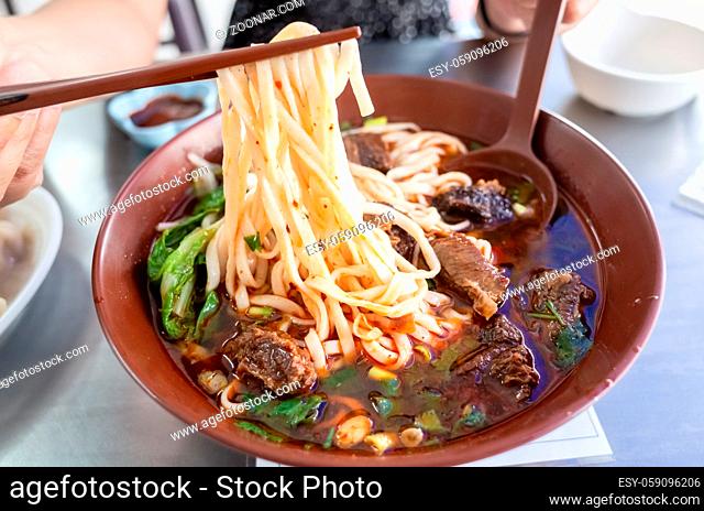 a bowl of hot braised beef noodle soup