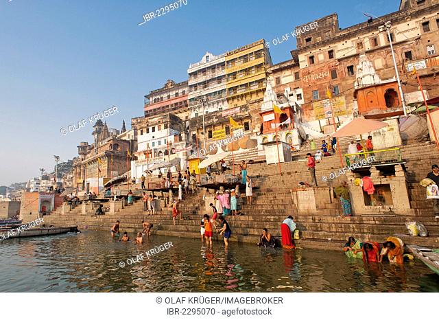 Bathers, boats, Ghats, holy stairs leading to the Ganges, city view in the early morning, Varanasi, Benares or Kashi, Uttar Pradesh, India, Asia