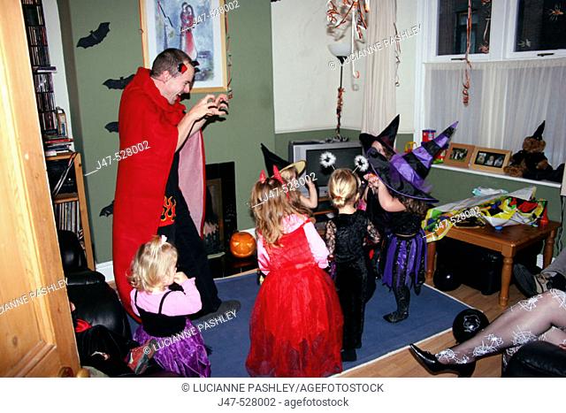 Group of 2-4 year old children dressed up in Halloween fancy dress, at a Halloween party