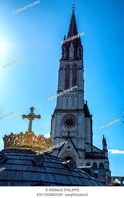 The gilded crown ad cross in Lourdes city
