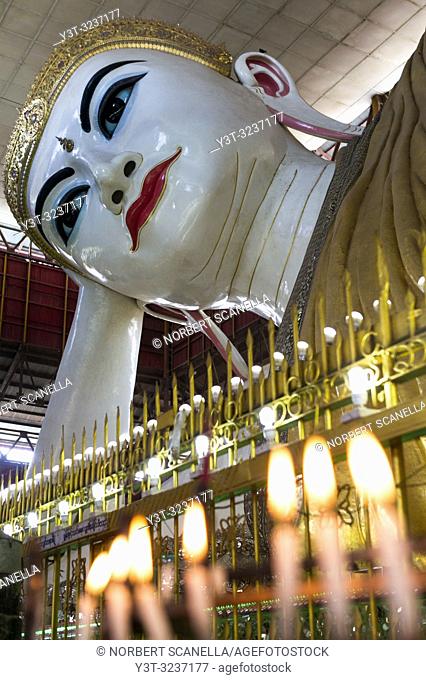 Myanmar (formerly Burma). Yangon (Rangoon). The Kyaukhtatgyi Pagoda is home to a large 70 meter long lying Buddha. His feet plants bear the 108 sacred marks...