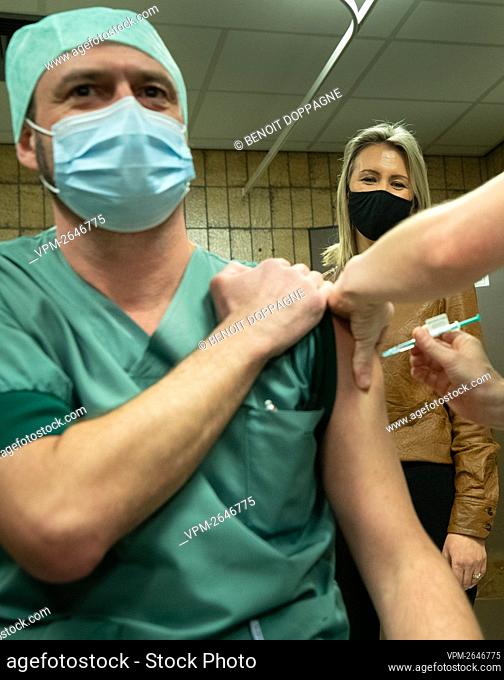 Defence minister Ludivine Dedonder watches as personnel of the Queen Astrid Military Hospital receives the second dose of the Covid-19 vaccine