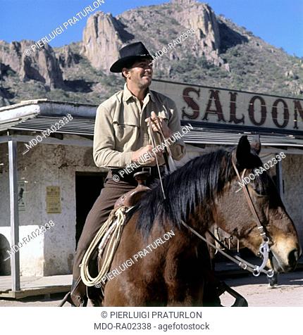 American actor and singer Den Martin (Dino Paul Crocetti) riding a horse on the set of the film 'The sons of Katie Elder'. USA, 1965