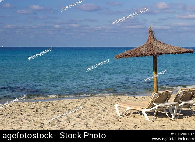 Spain, Formentera, Es Arenals, sunshade and beach chairs