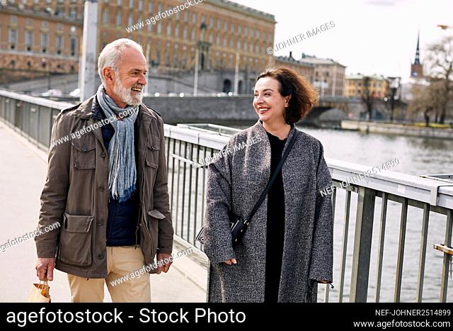 Mature couple walking through bridge