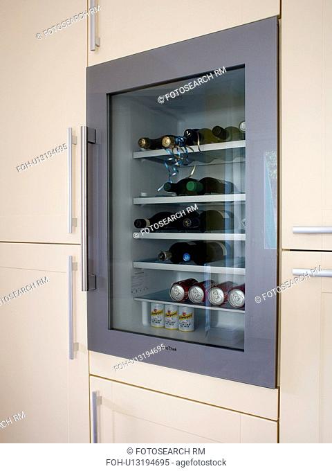 Close-up of wine-cooler in modern white kitchen unit