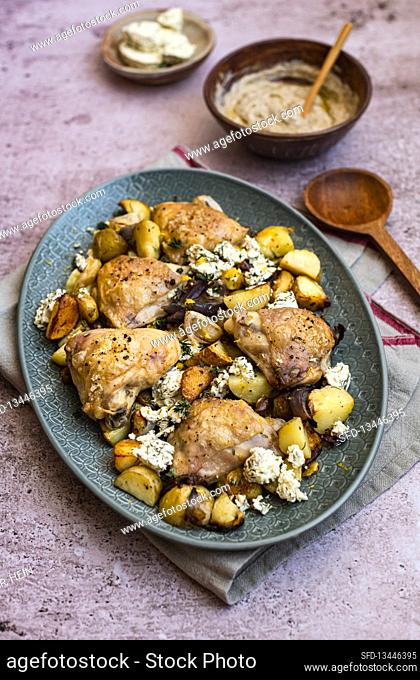 Roast chicken thighs with potatoes, red onions, feta and Harissa