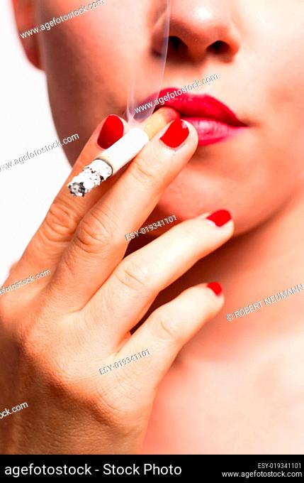Mund mit roten Lippen und roten Fingernägeln beim Rauchen V1