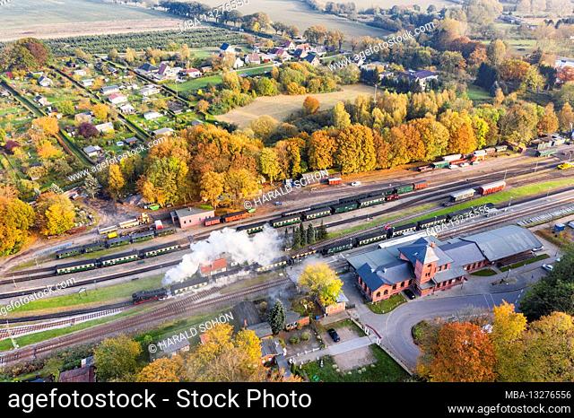 Germany, Mecklenburg-Western Pomerania, Rügen, Putbus, train station, reception building, steam locomotive, train leaves, oblique view, aerial view
