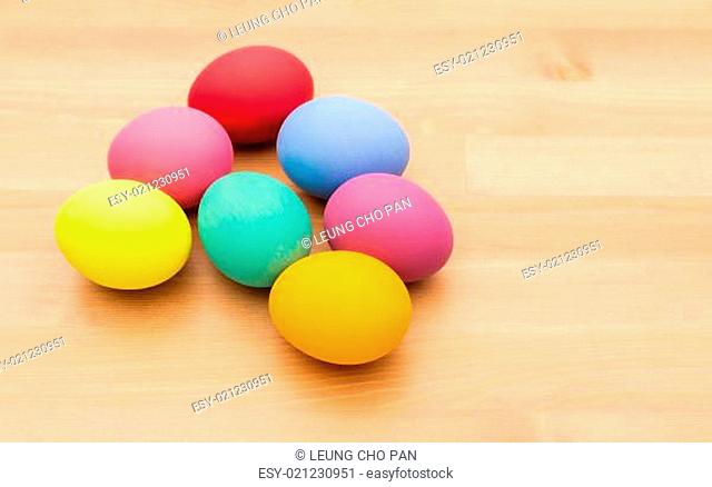 Colourful easter egg over wooden background