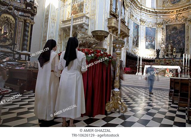 Nuns Standing In Front Of Altar Of Cathedral Dedicated To Sant Allesandro Dedicated To The Patron Saint Of City Of Bergamo