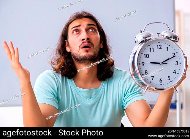 Young student preparing for exams in time management concept