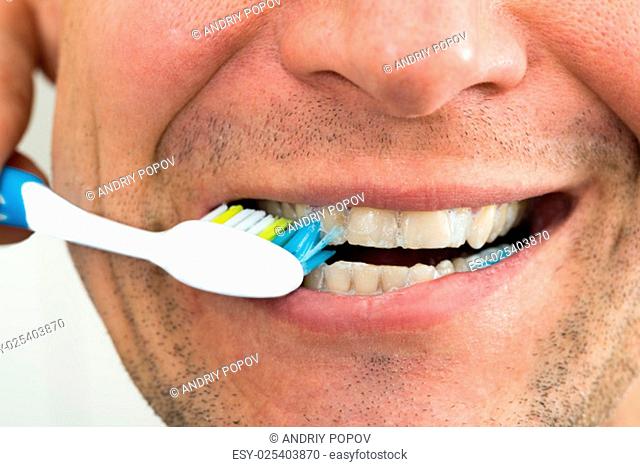 Close-up Photo Of A Man Brushing Teeth