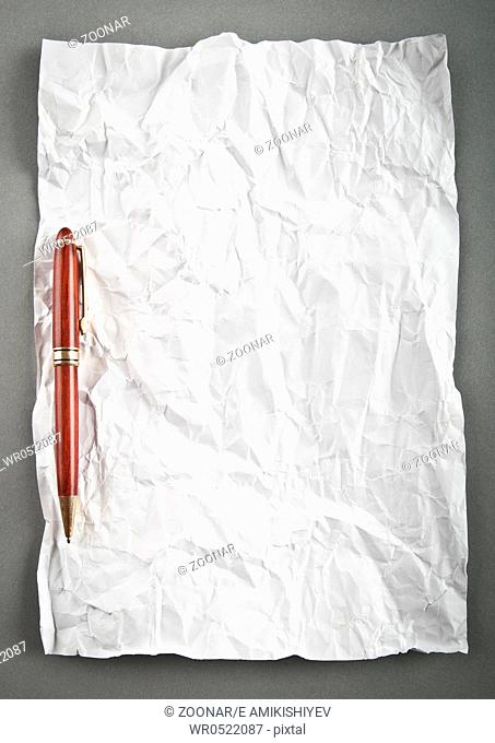 Wrinkled paper background with pen