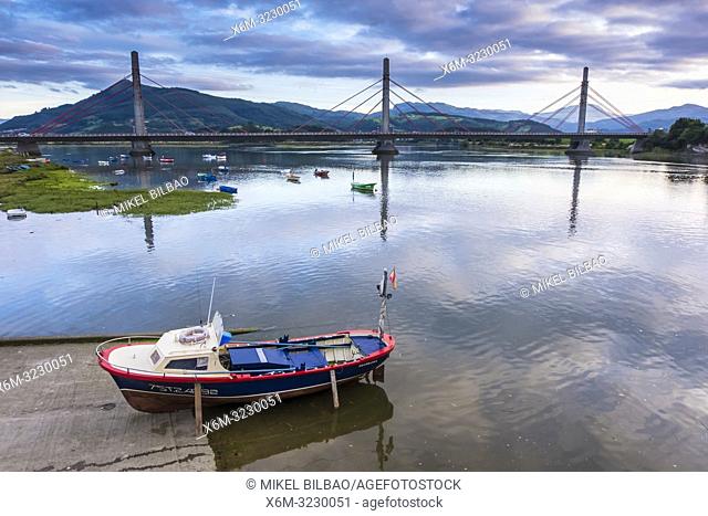 Bridge, boat and Ason river. Santoña, Victoria and Joyel Marshes Natural Park. Colindres, Cantabria, Spain, Europe