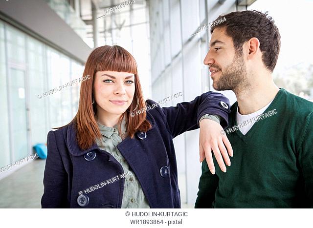 Portrait of young couple in airport building